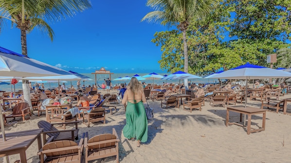 On the beach, white sand, sun loungers, beach umbrellas