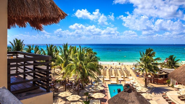 Un resort con piscina, playa y vista al océano.