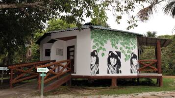 A small building with a sign indicating 'SAUNA' and a mural with portraits.