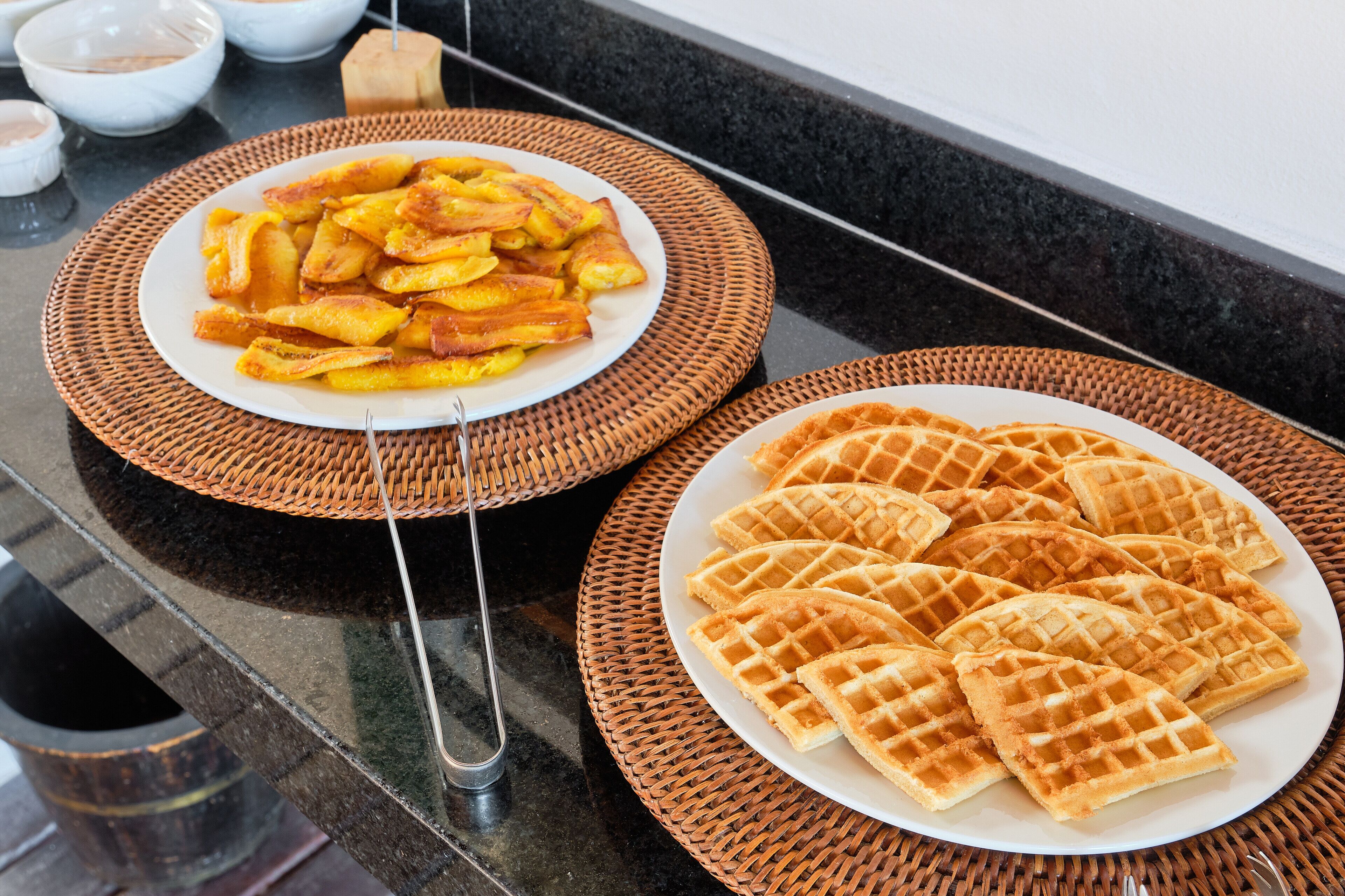Two plates of food on a kitchen counter.
