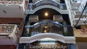 A multi-story building with a storefront named "Luxury Backpacker." - Luxury Backpackers (Hanoi)