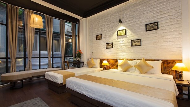 A hotel room with two beds, a bench, and a large window with curtains. - Luxury Backpackers (Hanoi)