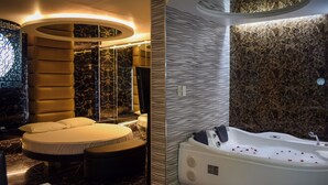 A modern bathroom with a bathtub, a round seating area, and a large mirror. - One Serenata Hotel Bacoor (Bacoor City)