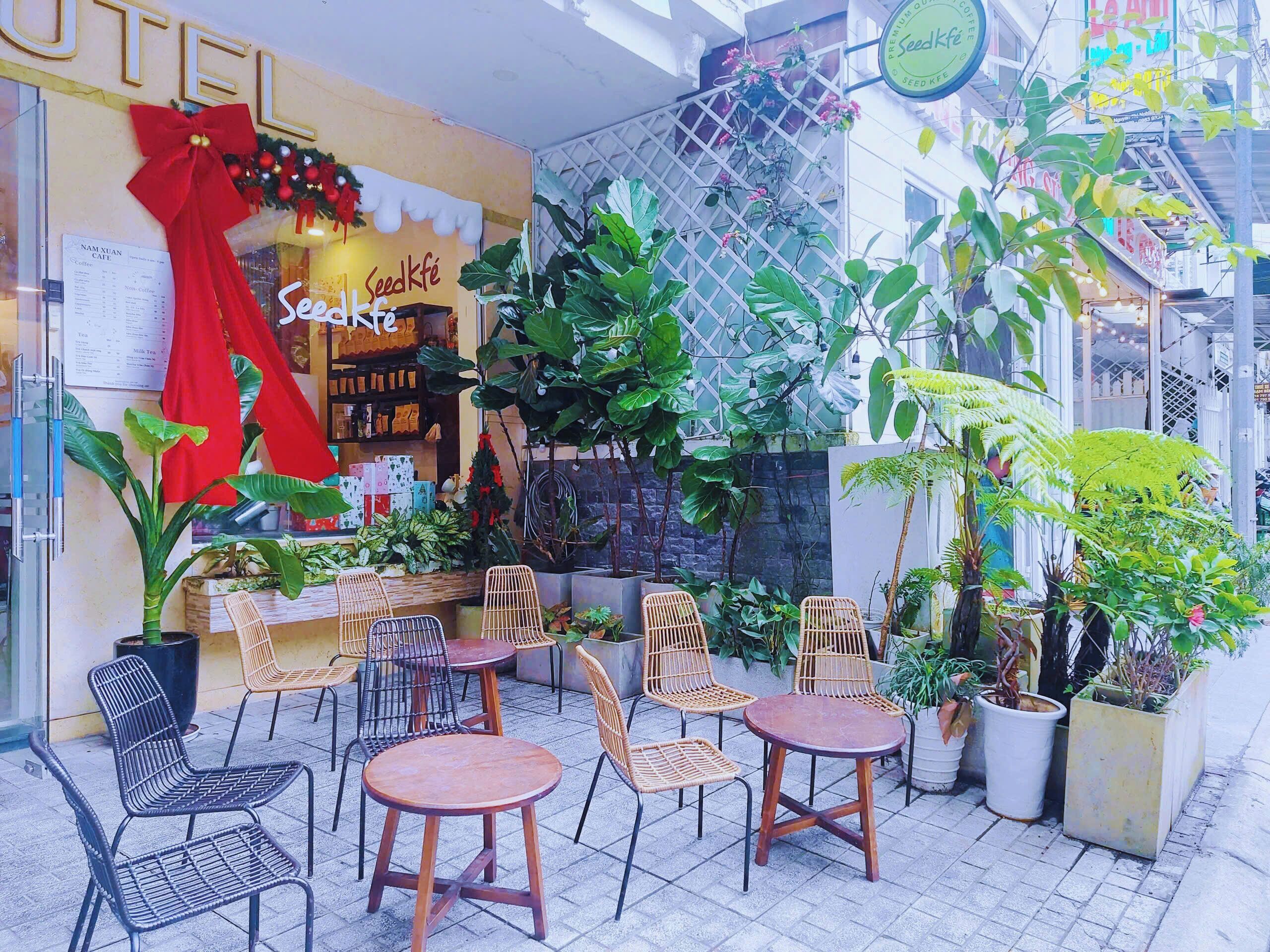 A café with outdoor seating, a menu board, and a coffee shop sign.