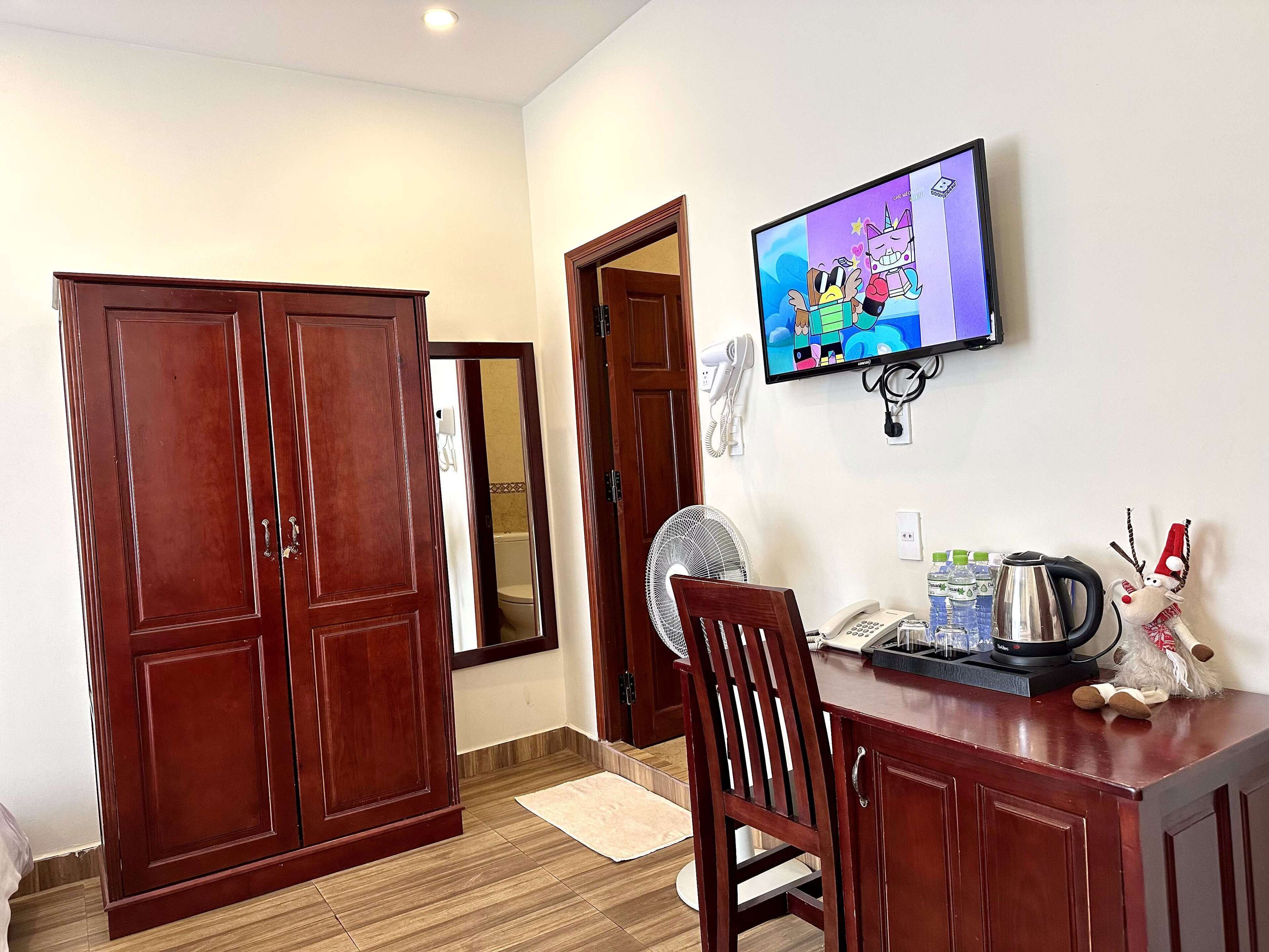 deluxe quadruple room, 2 double beds, non smoking, hill view | in-room safe, desk, laptop workspace, soundproofing