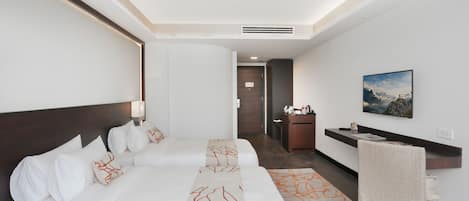 Una habitación de hotel con una cama grande, un escritorio y una silla.