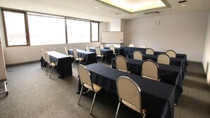 A conference room with tables and chairs, large windows, a whiteboard, and a clock on the wall. - Kotoni Green Hotel (Sapporo)