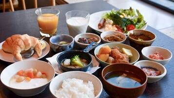 A table with various dishes including rice, soup, and a salad.