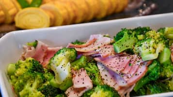 A dish with broccoli and ham.