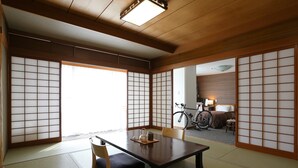 A traditional Japanese room with tatami flooring, a low wooden table, and shoji screens. - Komeyaclub Okutsu (Kagamino)