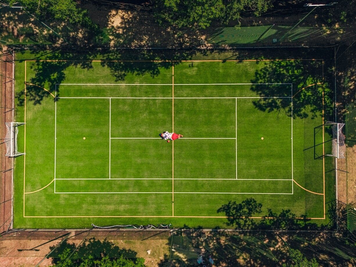 An aerial view of a sports field with goalposts and a net.