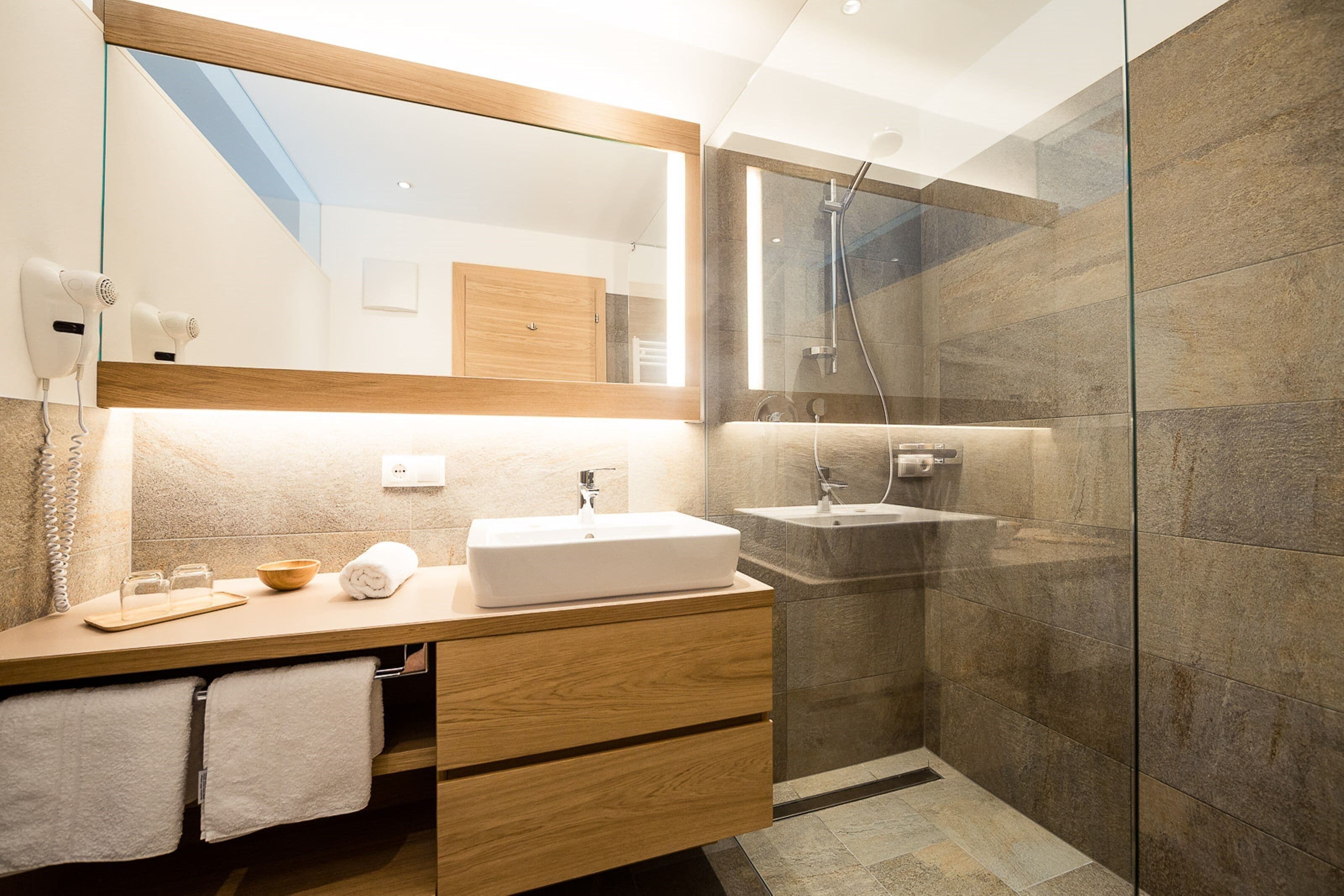 superior family room, balcony, mountain view | bathroom | shower, hair dryer, towels, soap