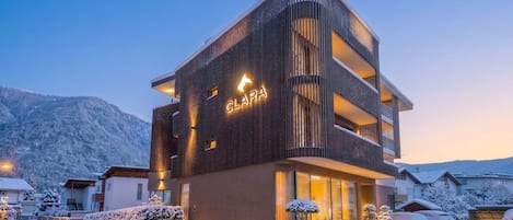 A multi-story hotel with a modern design, featuring a prominent 'CLARA' sign on the facade.