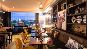 A restaurant with a cozy seating area, a bar, and a view of the cityscape.