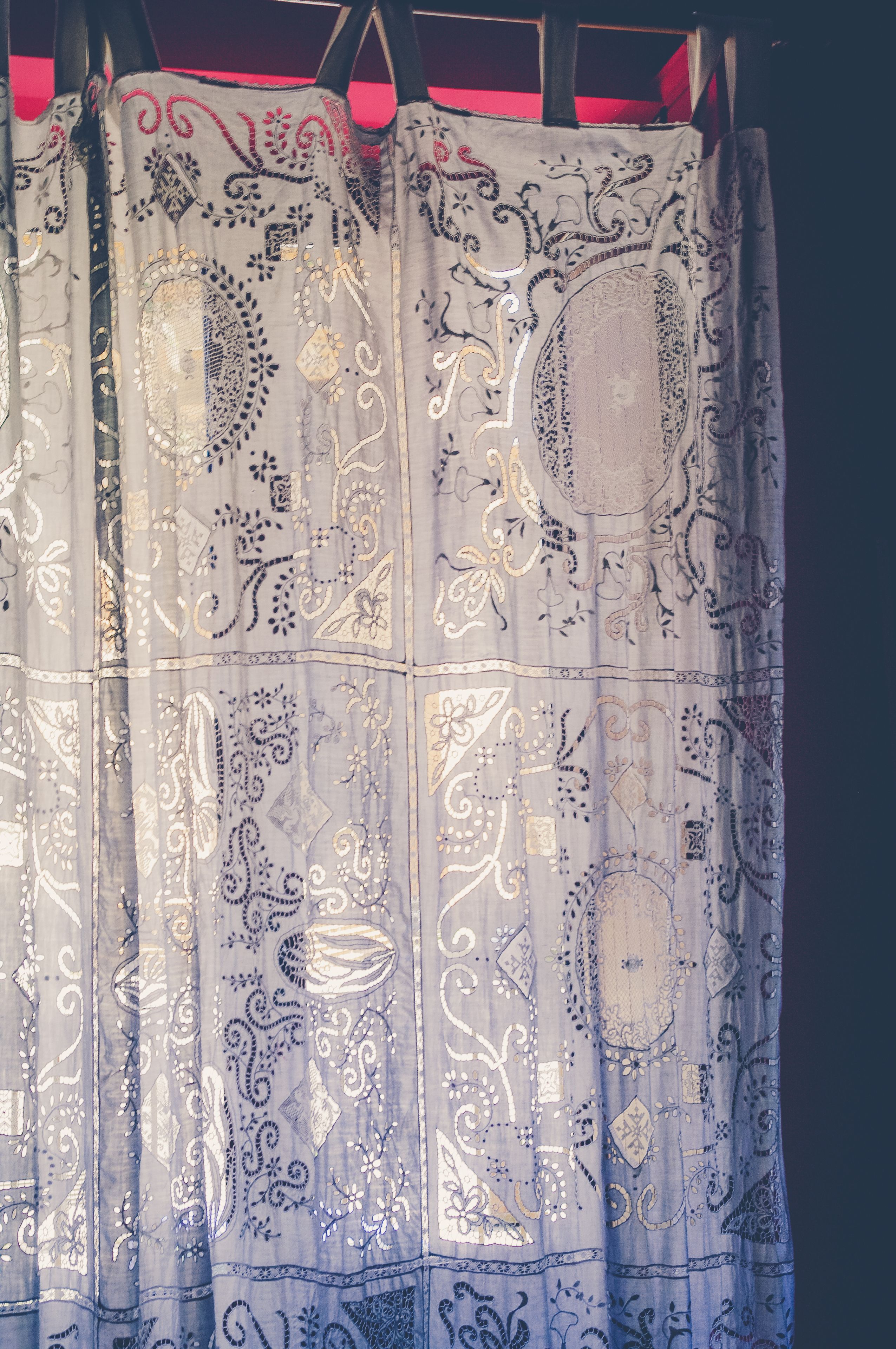 A curtain with intricate paisley and floral patterns.