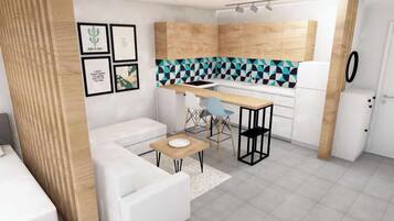 Een moderne keuken met een houten aanrechtblad, witte kasten en een geometrisch patroon op de achterwand. Er is een zithoek met een witte bank en een kleine tafel.