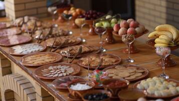 A buffet table with various food items and utensils.