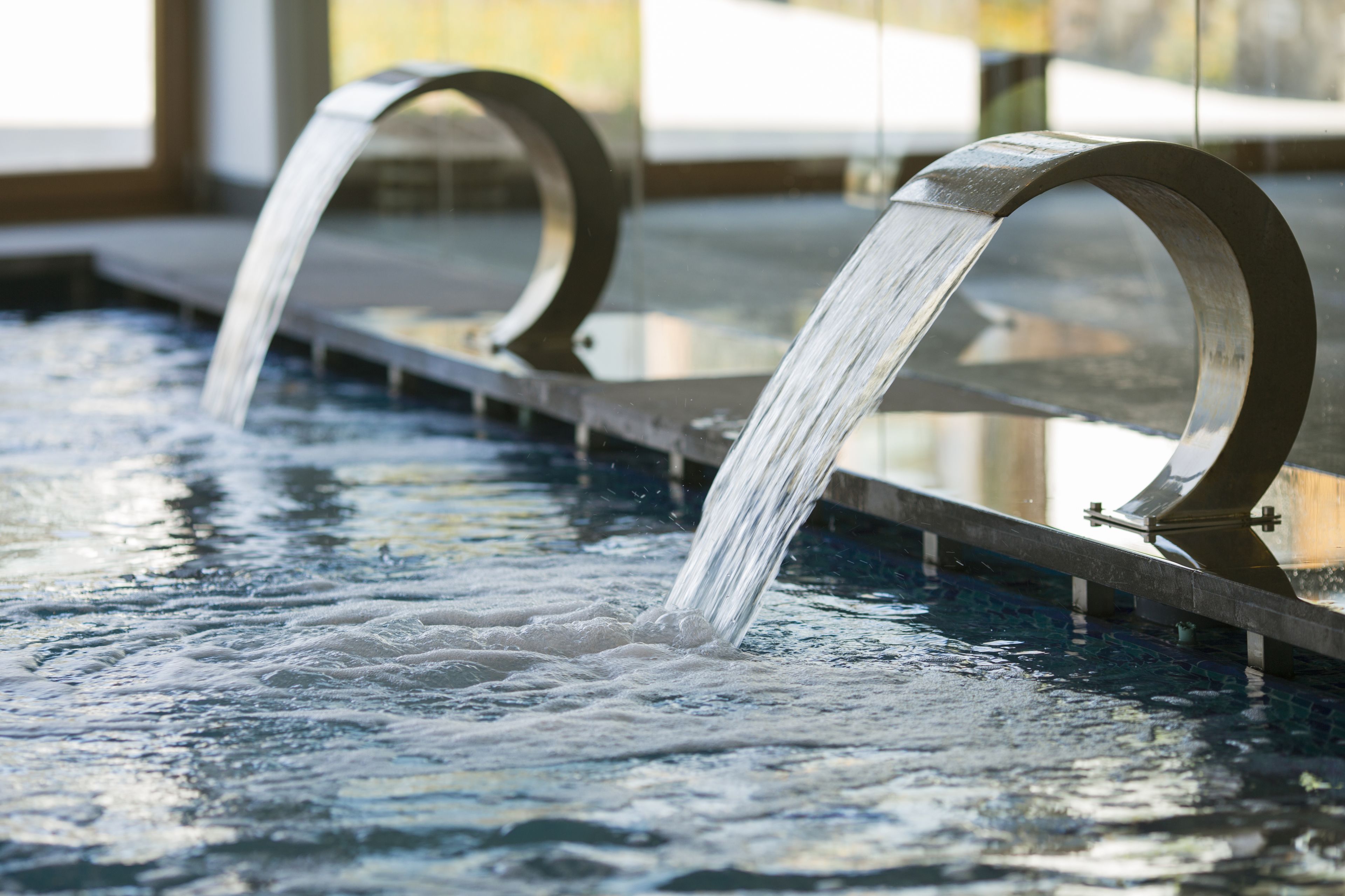 A water feature with two curved metal structures.