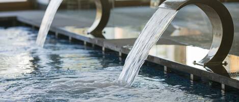 A water feature with two curved metal structures.