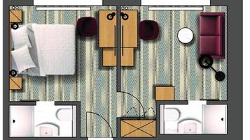 Indeling van een hotelkamer met een bed, twee zithoeken, een bank, een ronde tafel en een bijzettafeltje.