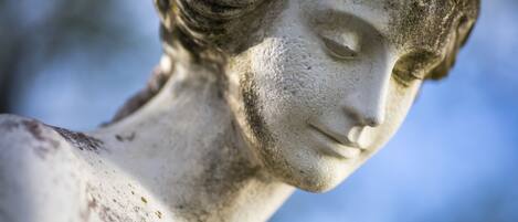 A close-up of a statue with a detailed head and upper torso.