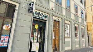 A building with a sign for 'Tabacci Ricevitoria Lotto'. - Novella Italy (Florence)