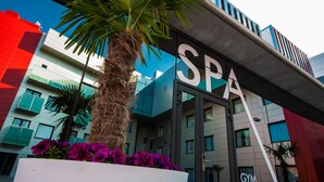 A modern building with a sign that reads "SPA" and "GYM WELLNESS".