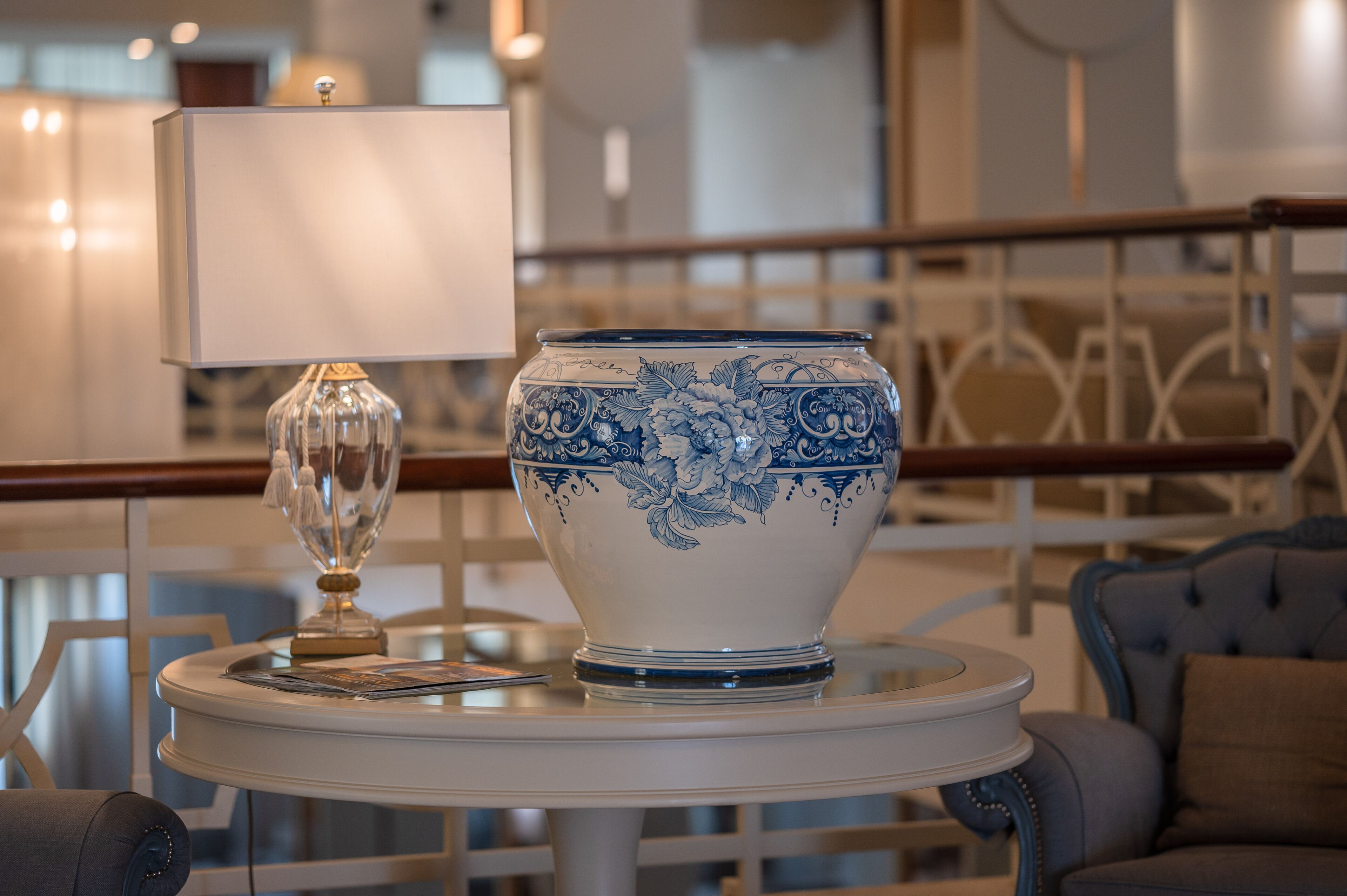A table with a decorative vase and a lamp.