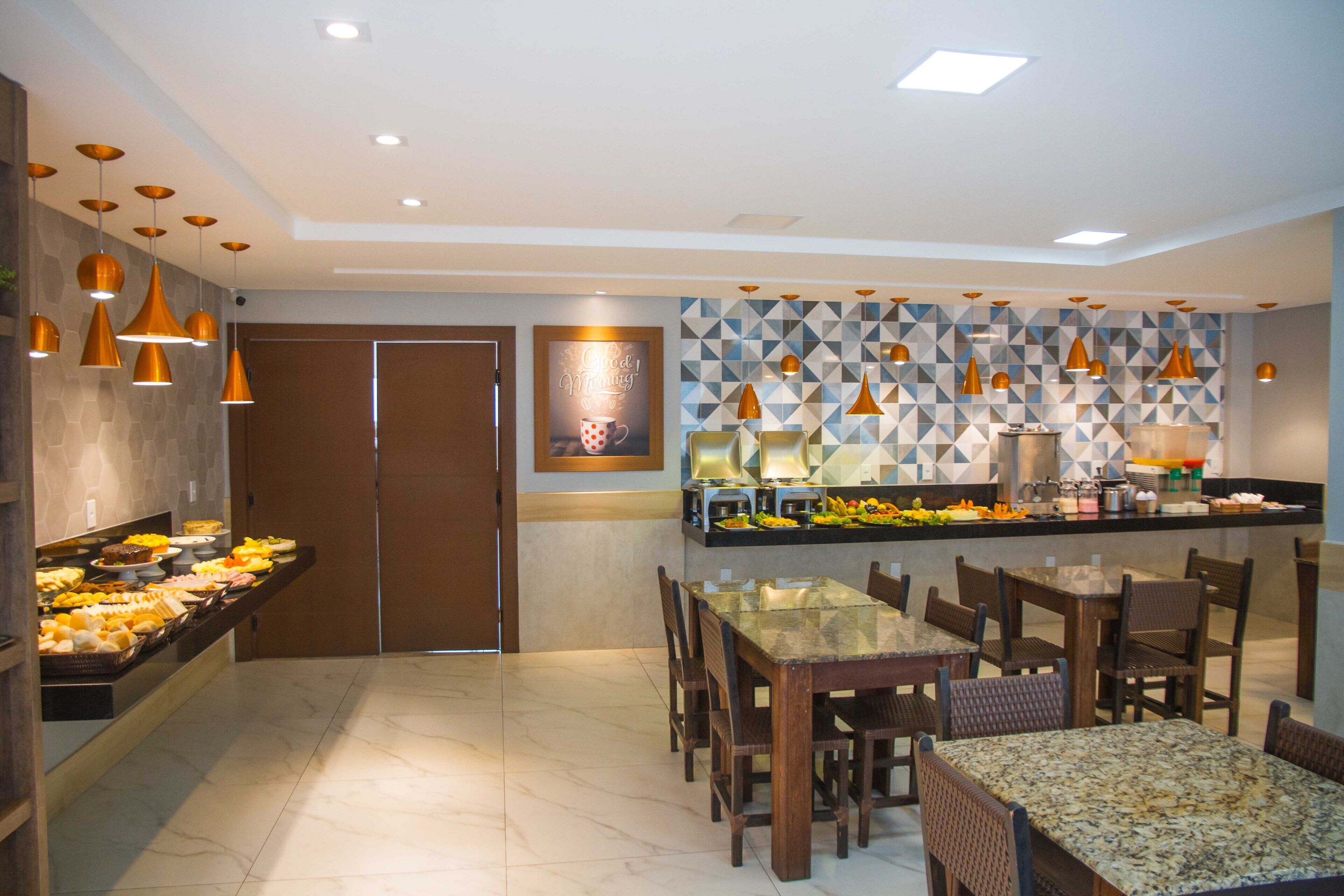 A modern dining area with a buffet, wooden chairs, and a patterned wall.