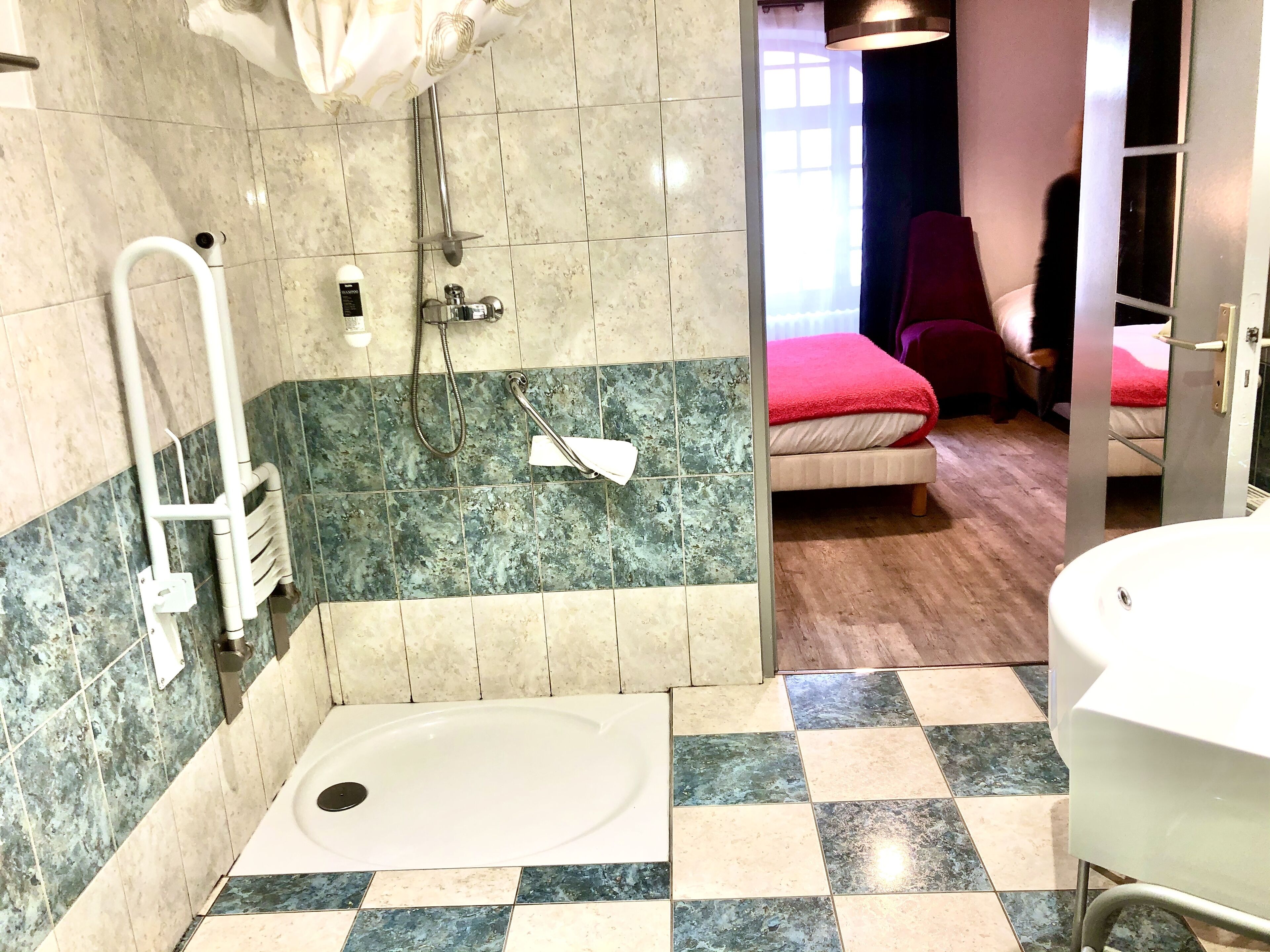 A bathroom with a shower, a bathtub, and a toilet.