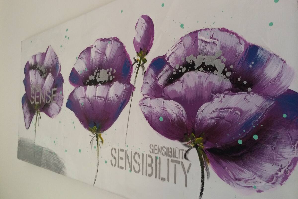A wall with a floral painting featuring purple flowers and the words "SENSE" and "SENSIBILITY".