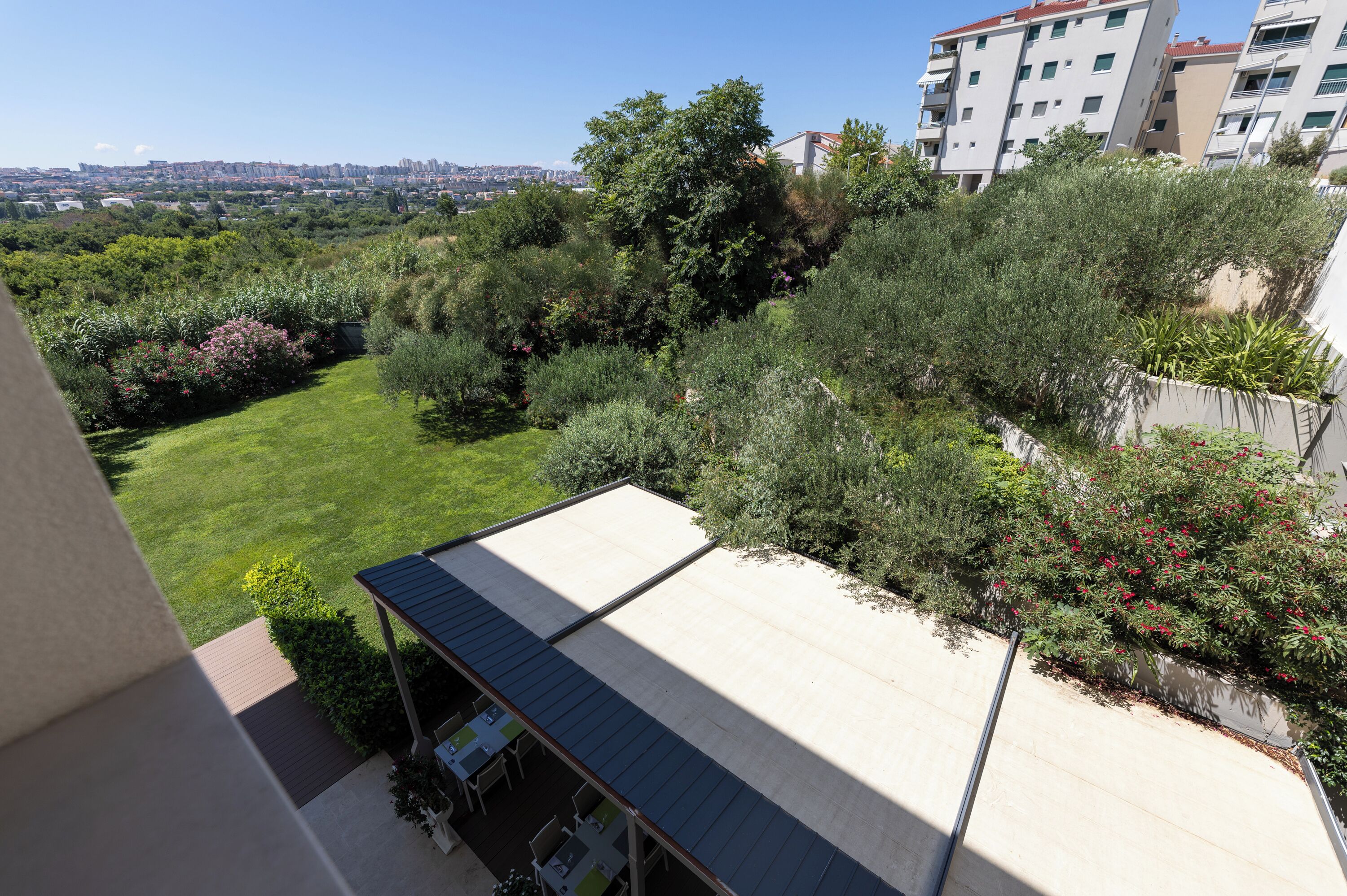 A rooftop garden with a view of a cityscape.