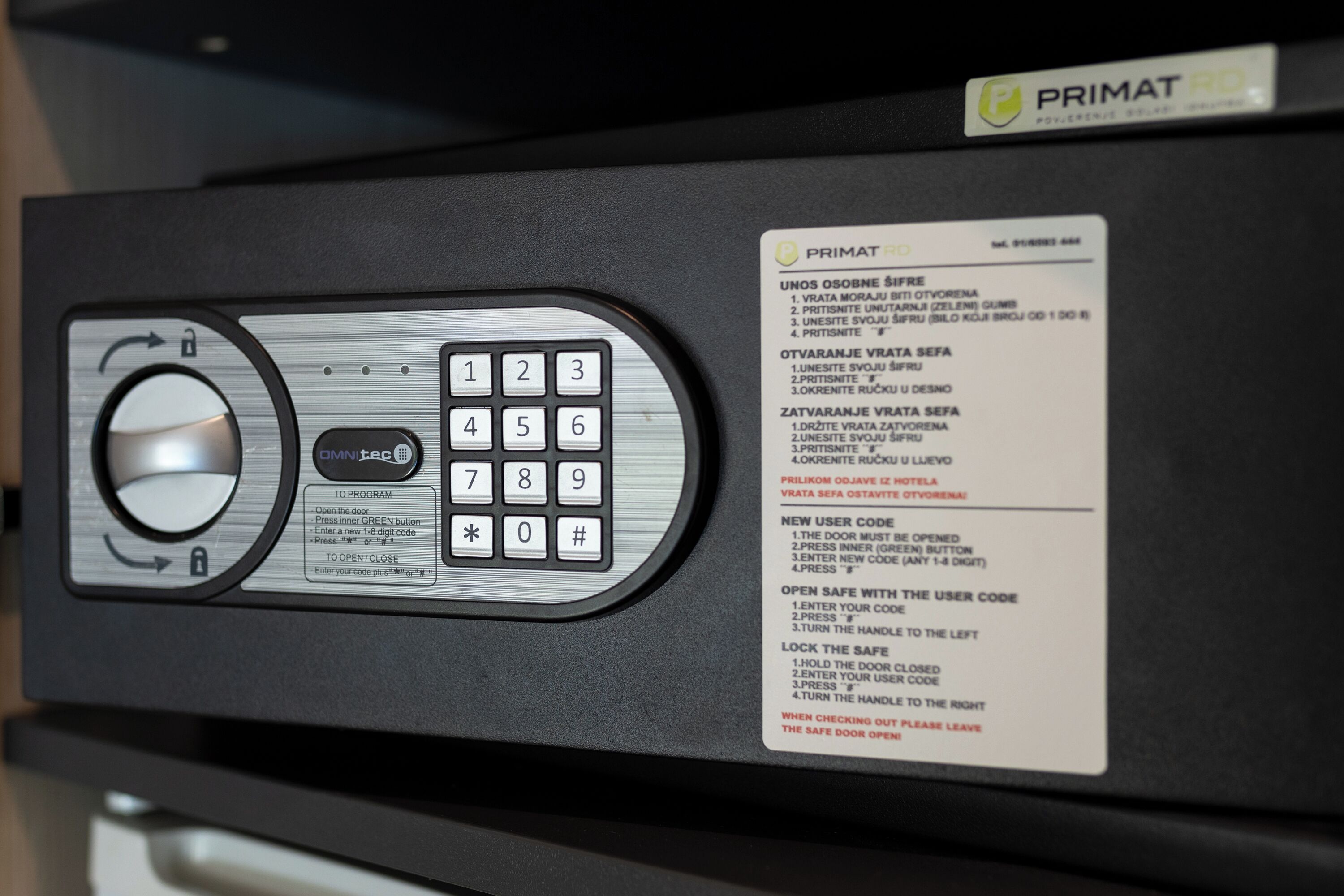 A security keypad with instructions for a safe door, including a user code entry process.