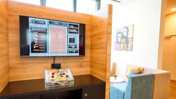 Relax in comfort with a large flat-screen TV, gaming console, and cozy seating area.