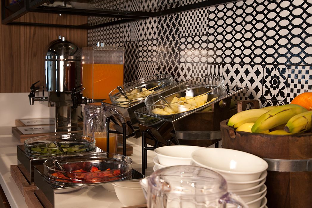 A buffet with various food items and a coffee machine.