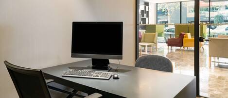 A modern office space with a desk, computer, and office chair.