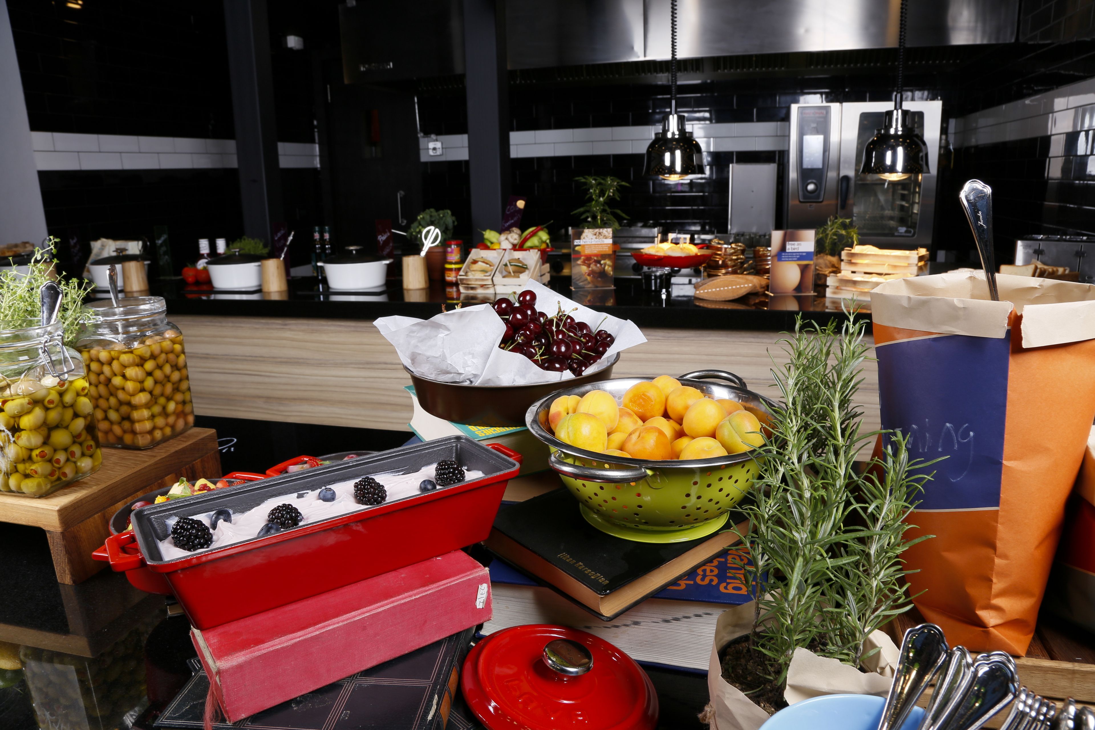 A kitchen counter with various food items and kitchenware.