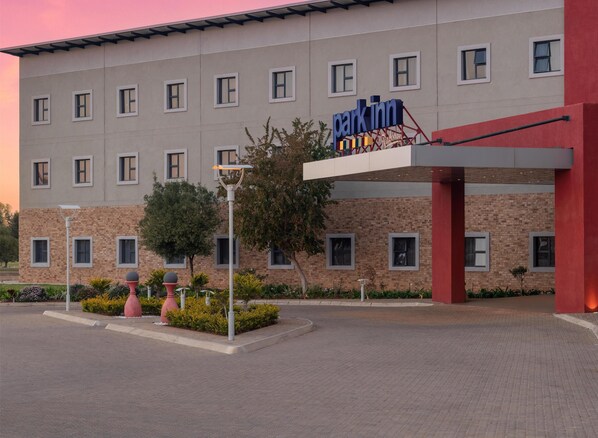 A building with a 'Park Inn' sign, featuring a modern design with multiple windows and a brick facade. - Park Inn by Radisson Polokwane (Polokwane)