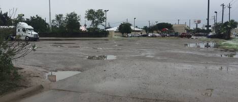 A large, open parking lot with a McDonald's sign in the distance.