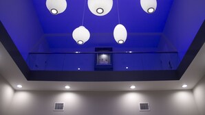 A room with a blue ceiling, recessed lighting, and a skylight. - Grand Villa Inn & Suites Chinatown (Houston)