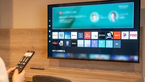 A flat-screen TV mounted on a wall displaying a streaming service interface with various channel logos. - JR East Hotel Mets Fukushima (Fukushima)