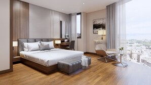 A modern hotel room with a large bed, a desk, a chair, and a view of the city.