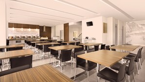A modern dining area with multiple tables and chairs, a kitchen area with a counter and appliances, and a large wall mural. - Amaris Hotel Padang (Padang)