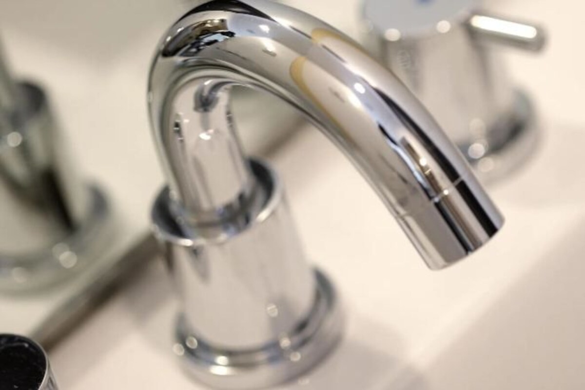 A chrome faucet with a curved spout.