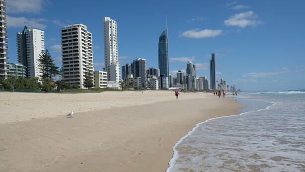 A beach with high-rise buildings in the background.