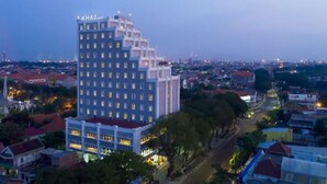 A multi-story hotel with a modern design, featuring a prominent sign at the top. - Khas Gresik (Gresik)