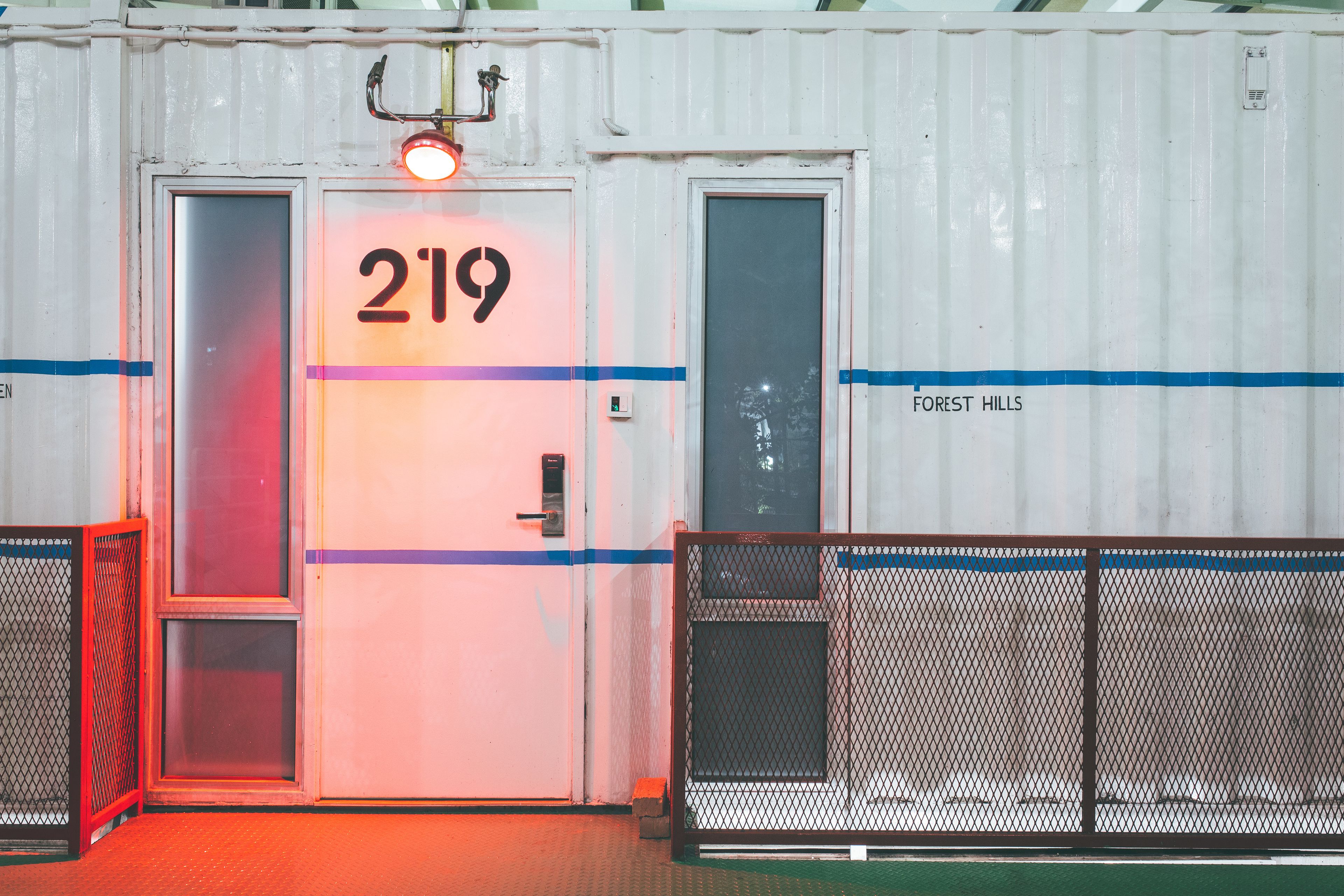 A white container with a door marked "219" and "FOREST HILLS" on the side.