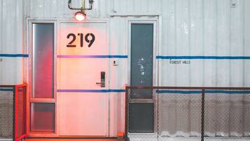 A white container with a door marked "219" and "FOREST HILLS" on the side.