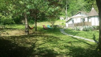 A house with a stone pathway leading to a grassy yard.
