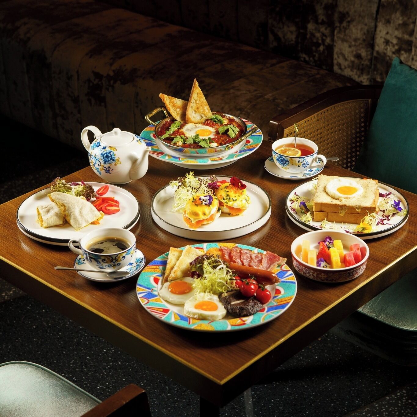 A breakfast table with various dishes including eggs, toast, and fruit.